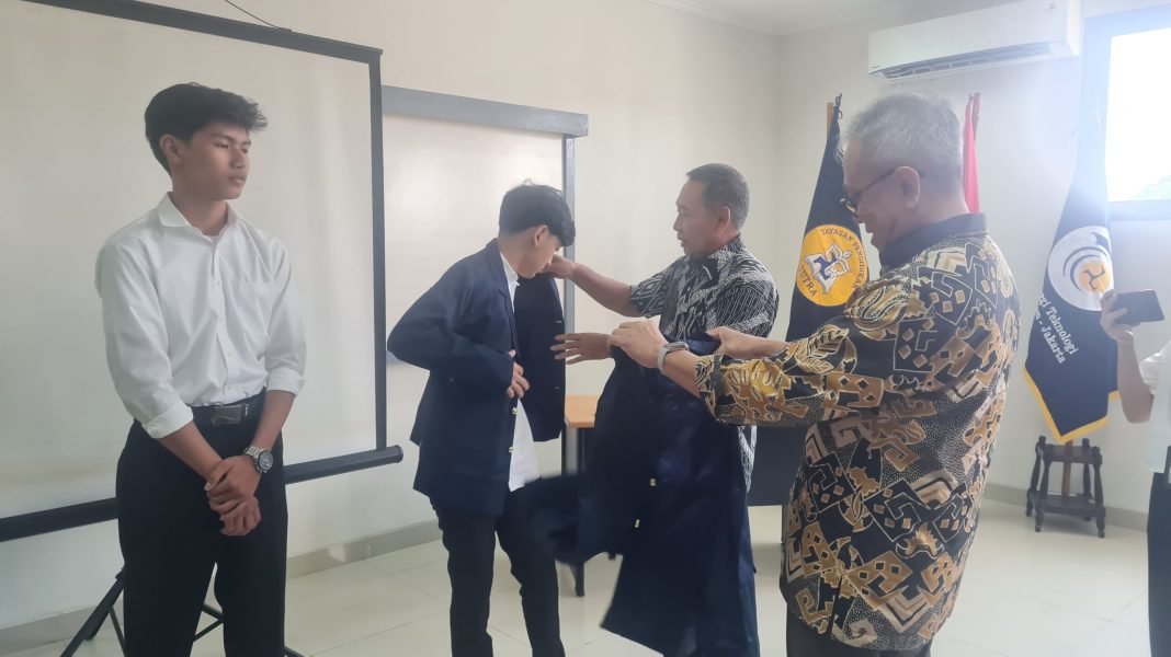 Simbolik penyerahan Jaket Almamater kepada mahasiswa baru. | Foto : M. Alif Syahdila R